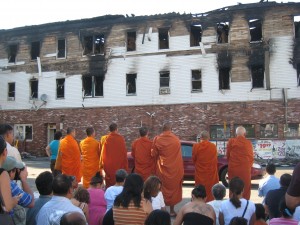 Buddhist Monks leading prayers for victims of fatal fire